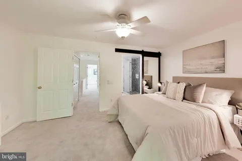 a spacious bedroom with a bed and a chandelier