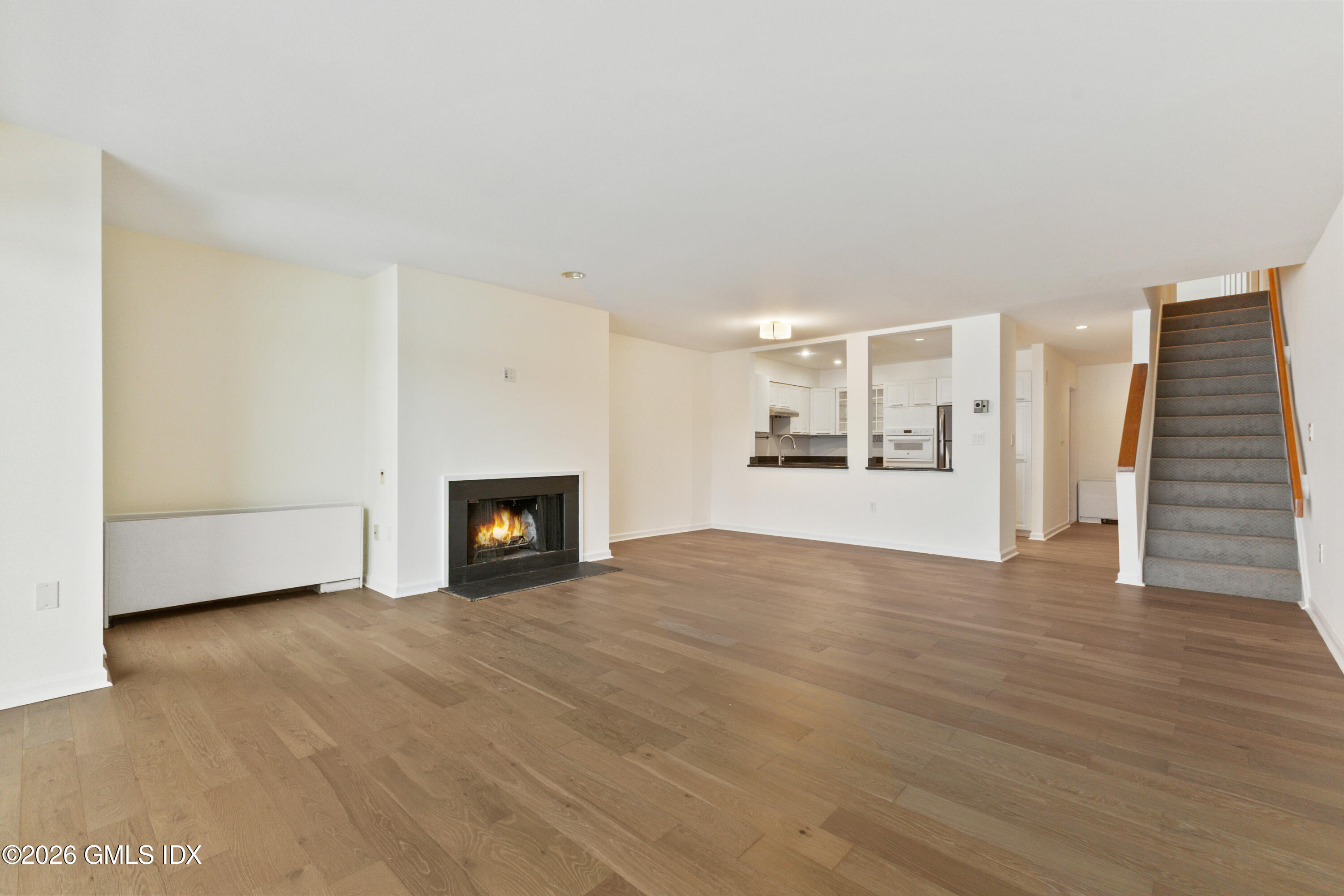 15 River Road, Unit 210 Cos Cob, CT 06807 - Photo 6 of 23 a view of a livingroom with a fireplace and wooden floor