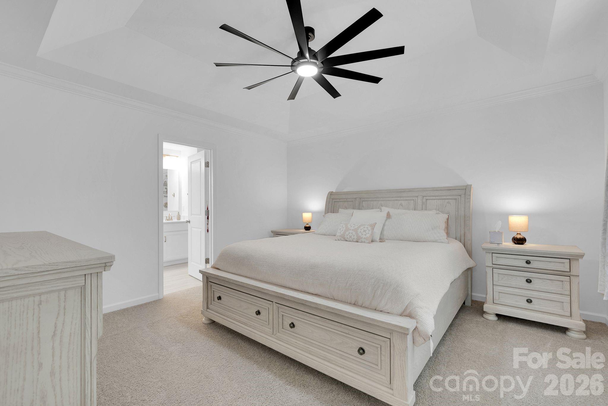 175 Aspire Circle Wingate, NC 28174 - Photo 20 of 24 a bedroom with a bed and a chandelier