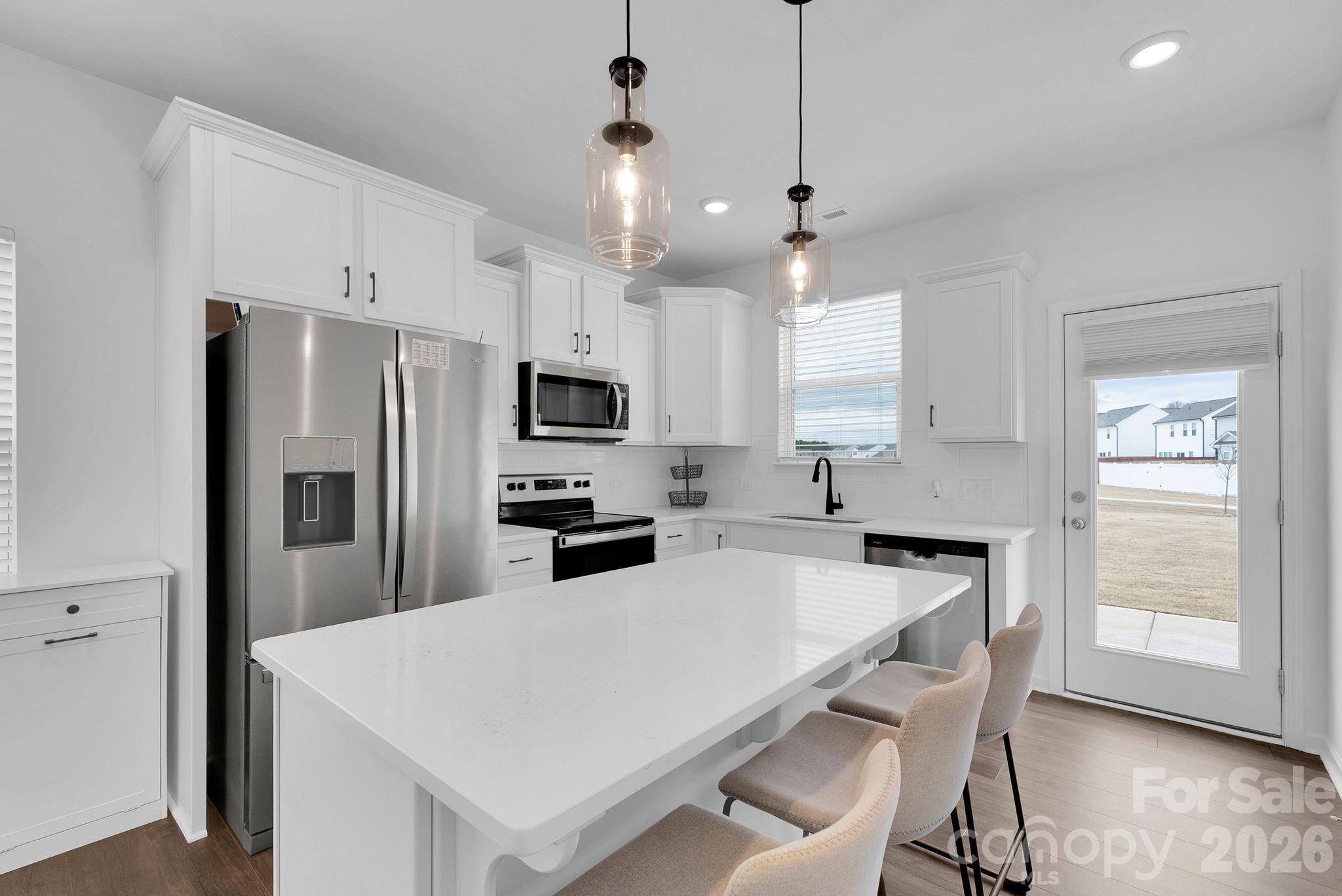 175 Aspire Circle Wingate, NC 28174 - Photo 2 of 24 a kitchen with white cabinets and stainless steel appliances