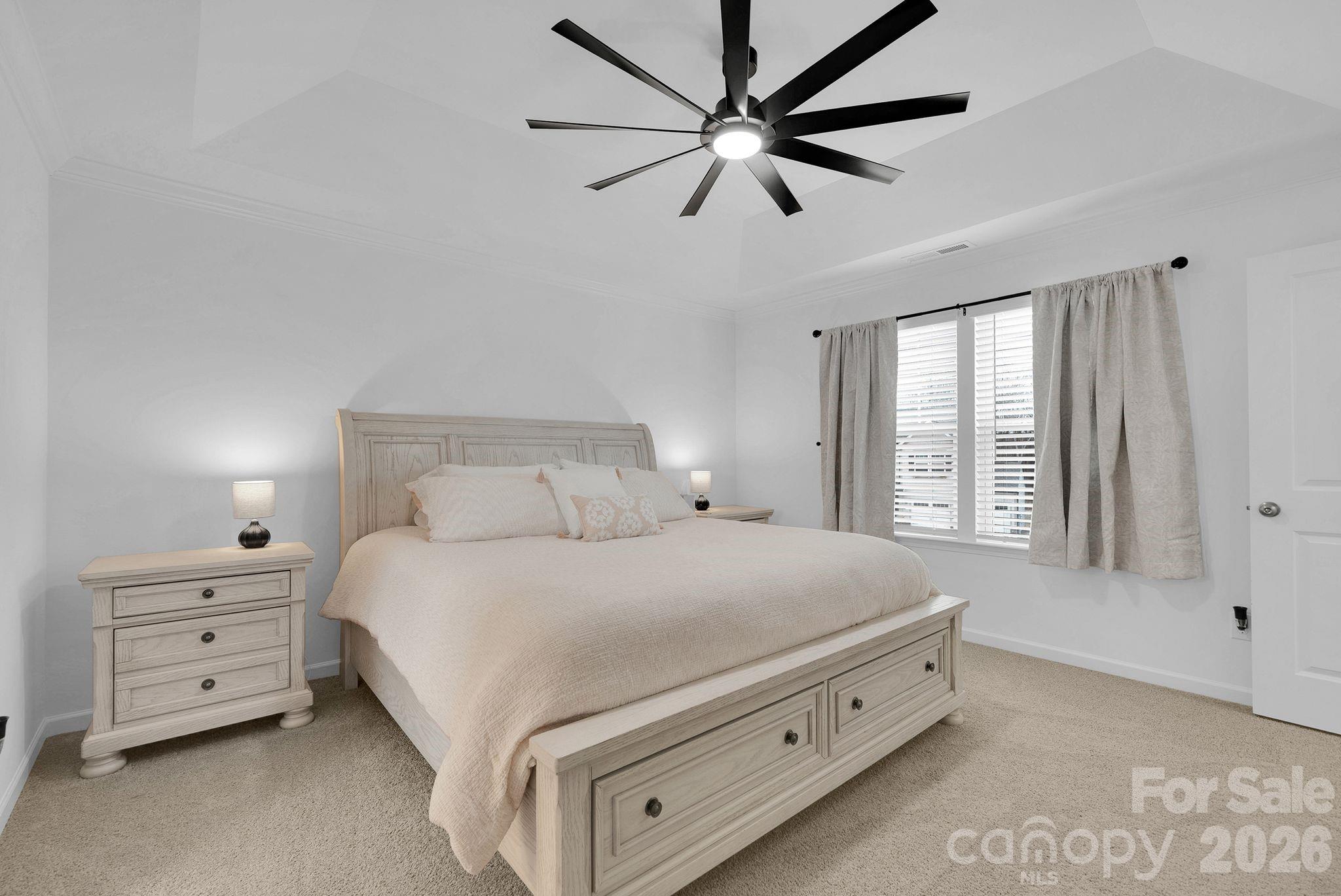 175 Aspire Circle Wingate, NC 28174 - Photo 21 of 24 a bedroom with a bed and a chandelier fan