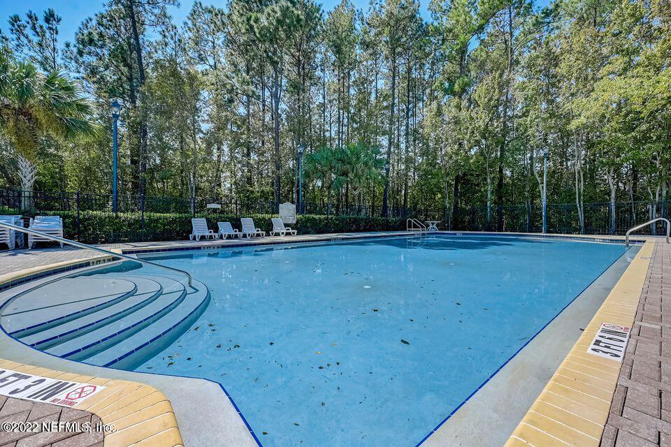7920 Merrill Road, Unit 101 Jacksonville, FL 32277 - Photo 14 of 14 a view of a swimming pool with a patio