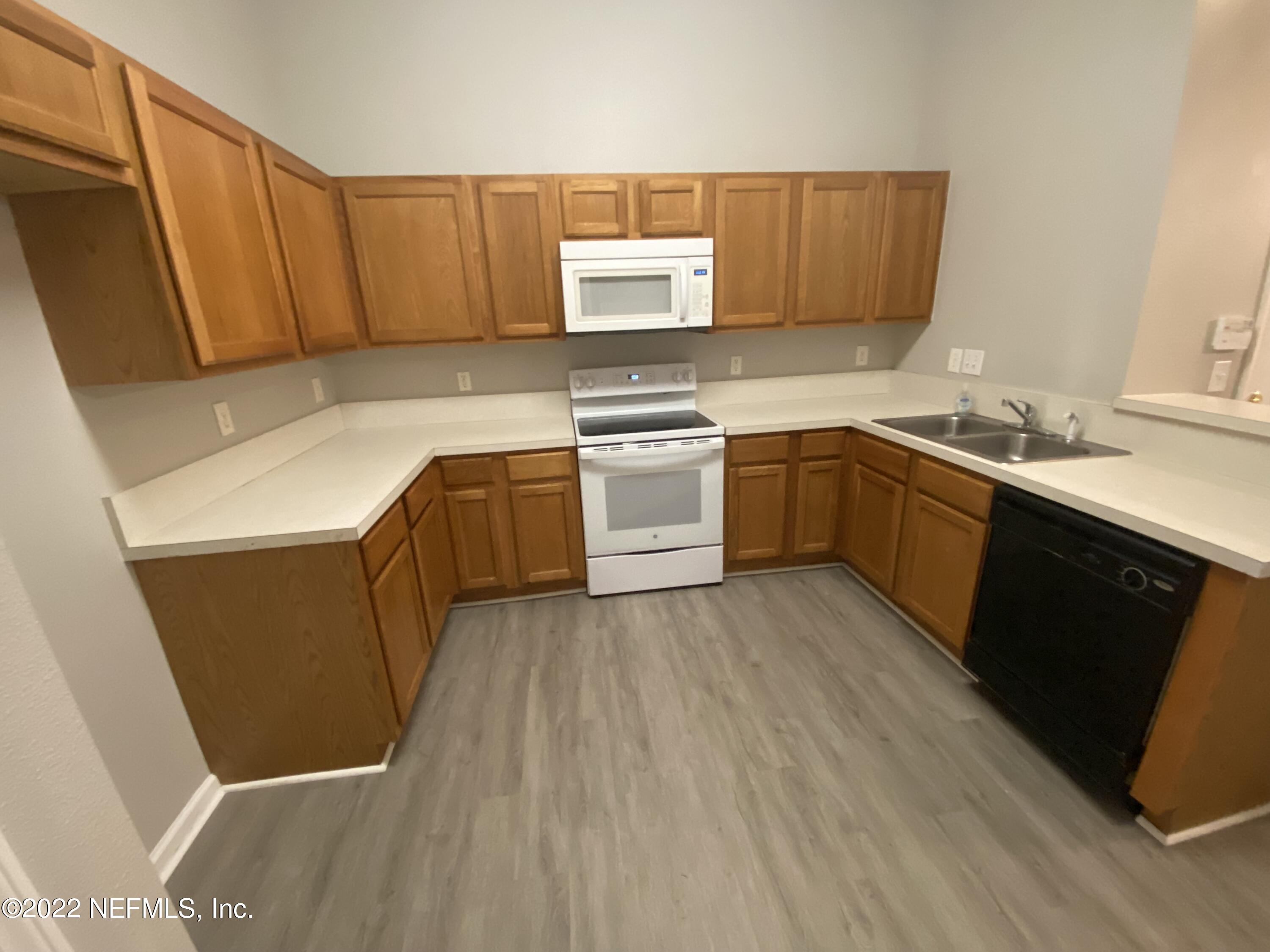 7920 Merrill Road, Unit 101 Jacksonville, FL 32277 - Photo 4 of 14 a kitchen with sink and cabinets