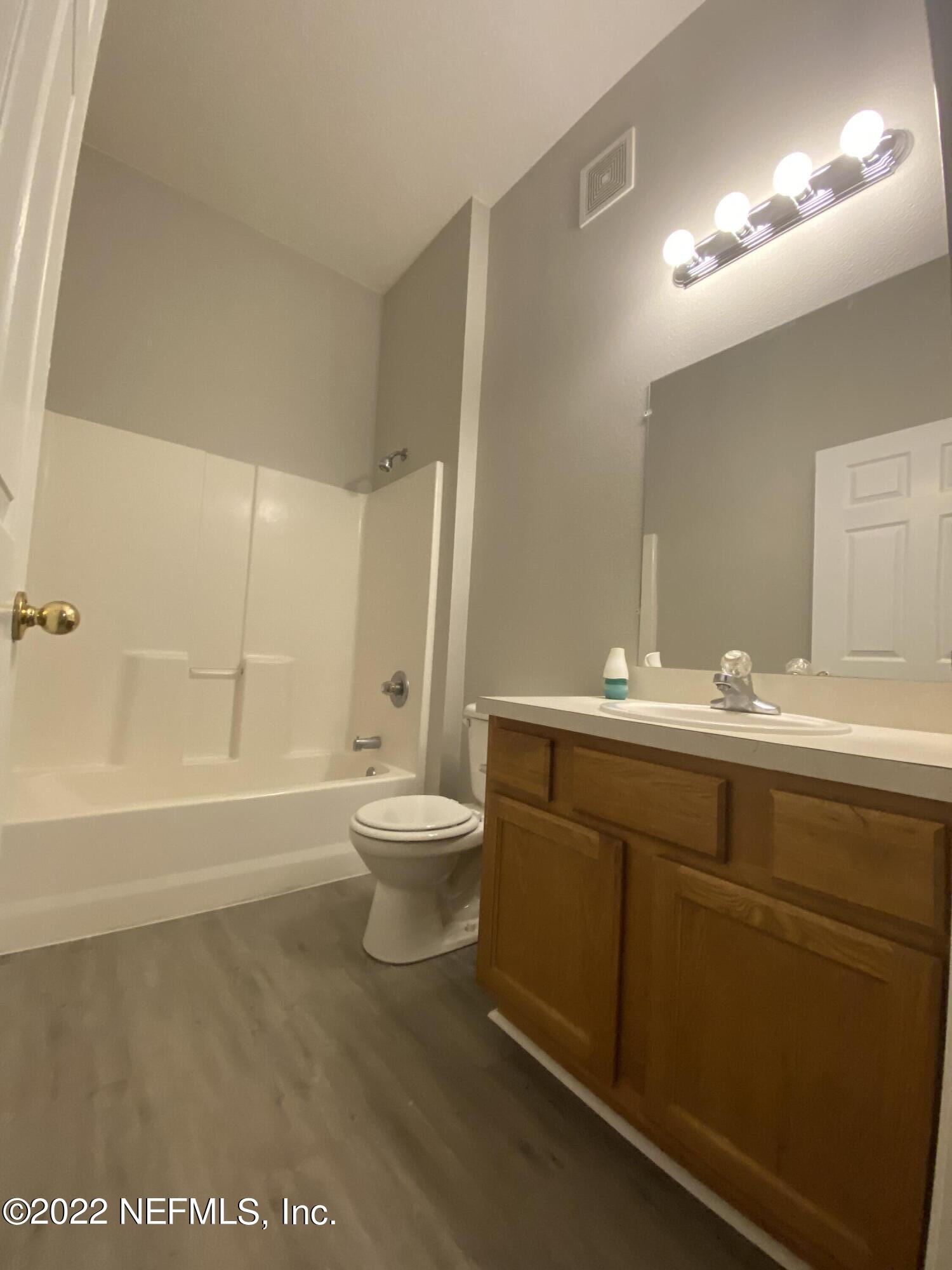 7920 Merrill Road, Unit 101 Jacksonville, FL 32277 - Photo 6 of 14 a bathroom with a sink a toilet and shower