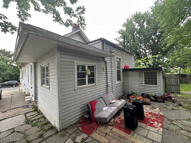 7701 Dercum Road Cleveland, OH 44105 - Photo 21 of 23 Back of house featuring a storage unit and a patio area