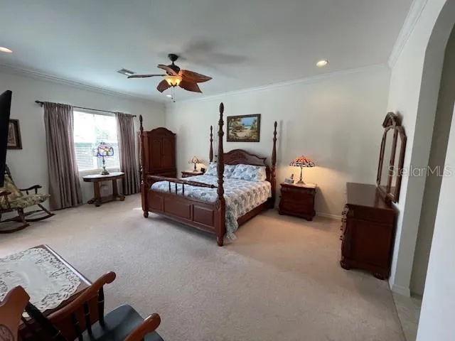 a bedroom with furniture and a flat screen tv
