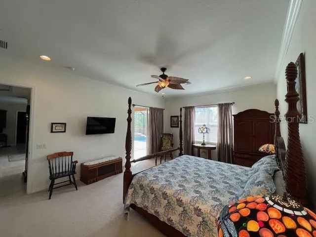a bedroom with furniture and a flat screen tv