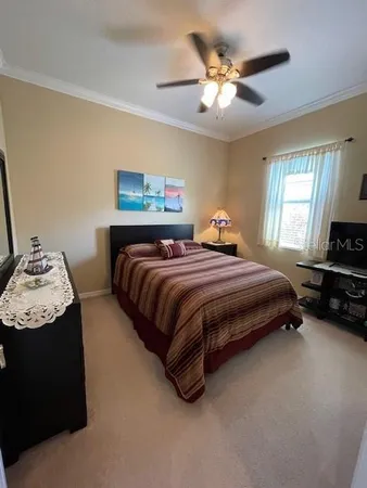 a bedroom with a bed and a chandelier