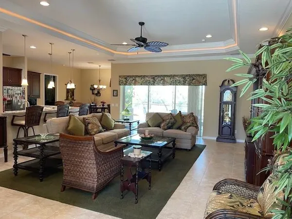 a living room with furniture and a chandelier