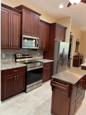 a kitchen with a sink stove and refrigerator