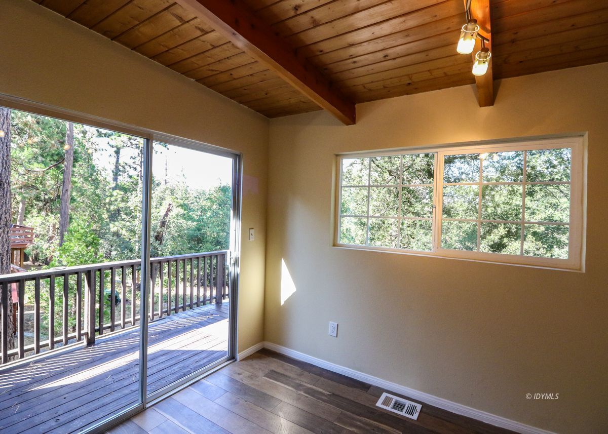 25585 Seneca Road Idyllwild, CA 92549 - Photo 16 of 24 a view of a room with wooden floor and a window