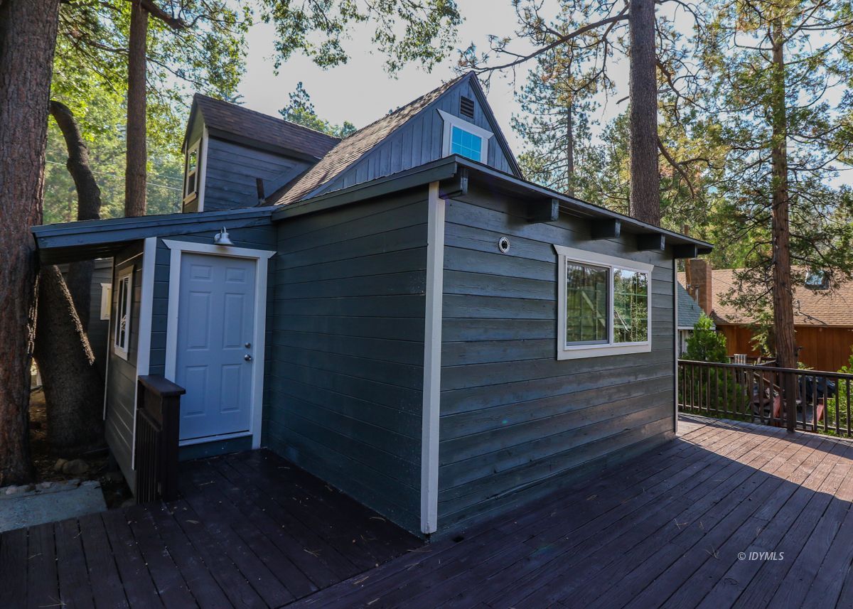 25585 Seneca Road Idyllwild, CA 92549 - Photo 19 of 24 a view of wooden house with a small yard and wooden floor