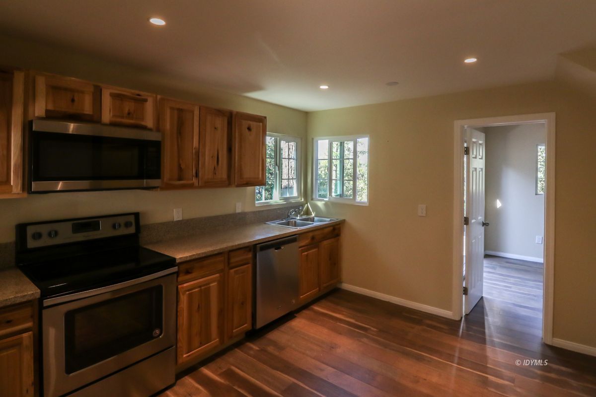 25585 Seneca Road Idyllwild, CA 92549 - Photo 4 of 24 a kitchen with stainless steel appliances stove microwave and cabinets