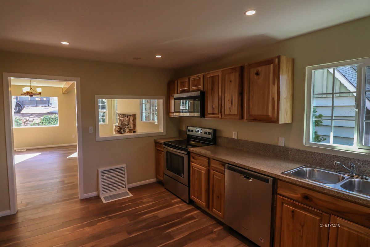 25585 Seneca Road Idyllwild, CA 92549 - Photo 5 of 24 a kitchen with stainless steel appliances granite countertop a sink stove and cabinets