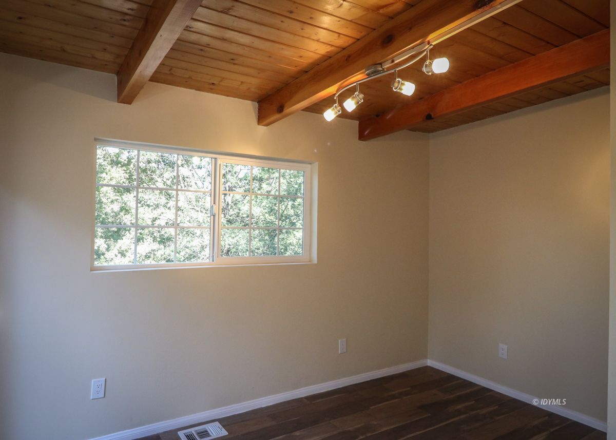 25585 Seneca Road Idyllwild, CA 92549 - Photo 6 of 24 a view of empty room with wooden floor and fan