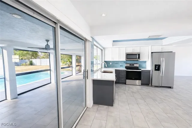 a kitchen with stainless steel appliances granite countertop a refrigerator and a stove