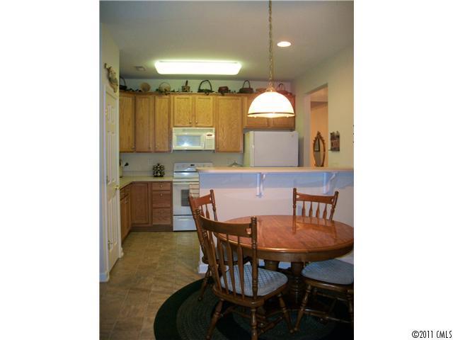 1671 Onyx Ridge, Unit 1671 Fort Mill, SC 29708 - Photo 6 of 15 a kitchen with a dining table chairs and a mirror