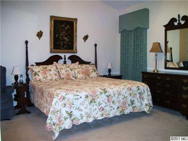 1671 Onyx Ridge, Unit 1671 Fort Mill, SC 29708 - Photo 9 of 15 a bedroom with a bed and a mirror