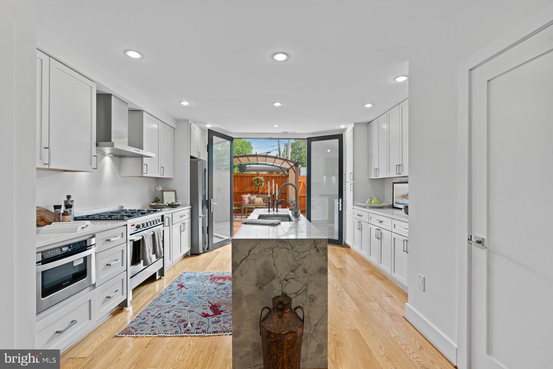 320 A Street Northeast Washington, DC 20002 - Photo 36 of 36 a kitchen with stainless steel appliances granite countertop a stove top oven a sink a refrigerator and white cabinets with wooden floor
