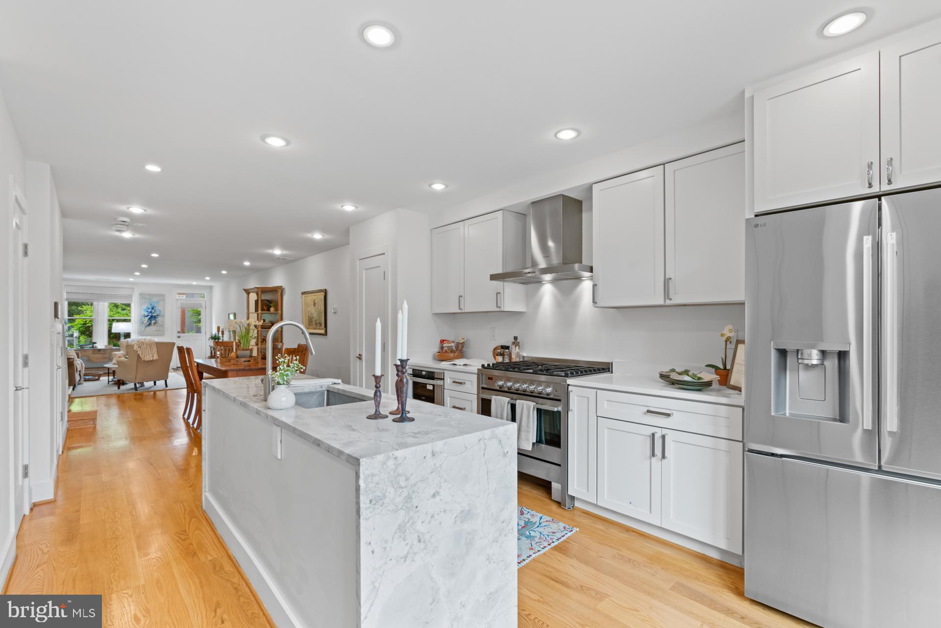 320 A Street Northeast Washington, DC 20002 - Photo 3 of 36 a kitchen with stainless steel appliances granite countertop a refrigerator a sink dishwasher a stove and white cabinets with wooden floor