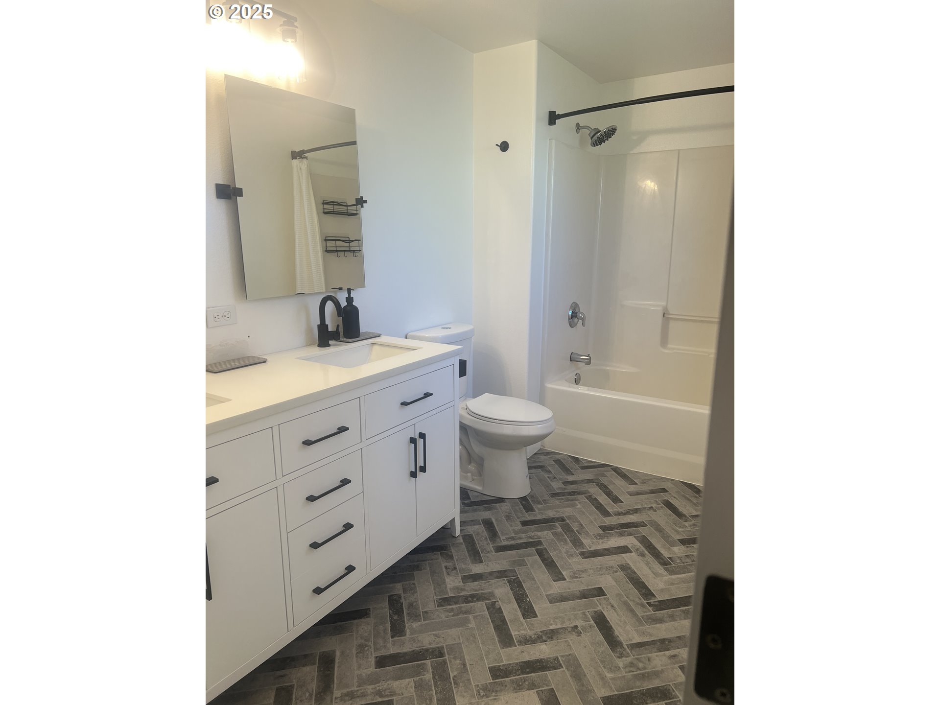 5752 Mica Street Springfield, OR 97478 - Photo 20 of 45 a bathroom with a granite countertop sink toilet mirror and a bathtub