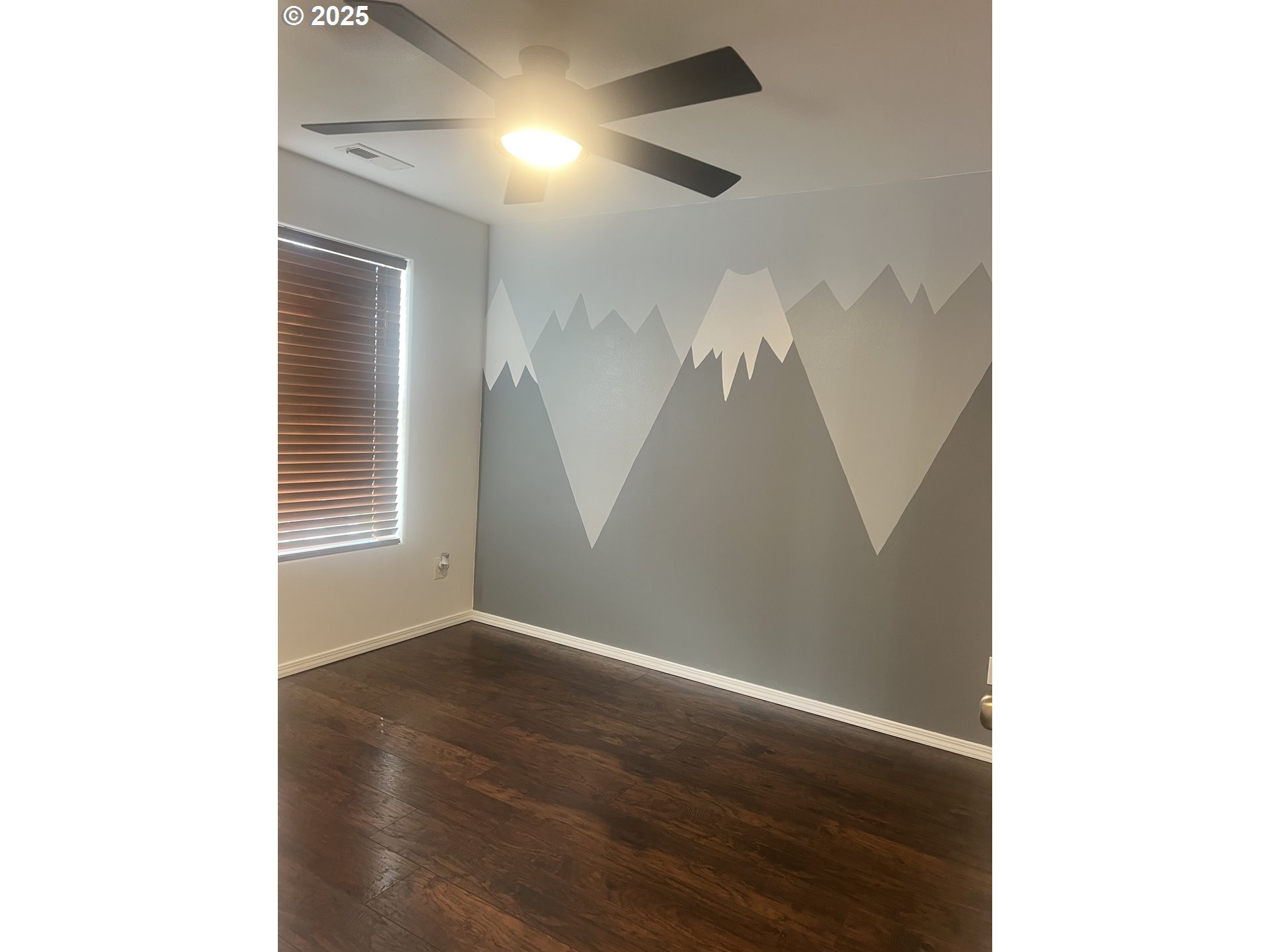 5752 Mica Street Springfield, OR 97478 - Photo 23 of 45 a view of a livingroom with wooden floor and a ceiling fan