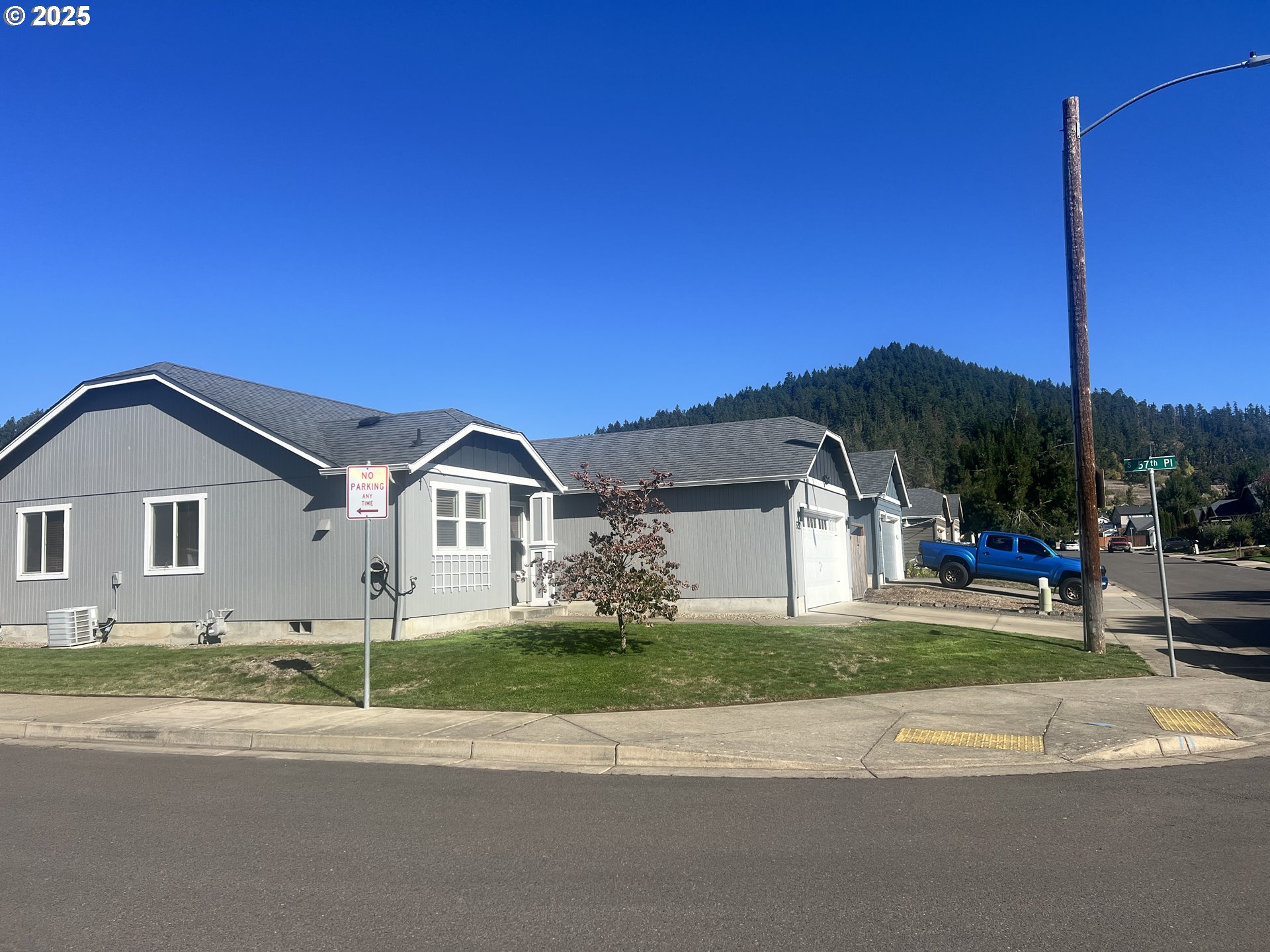 5752 Mica Street Springfield, OR 97478 - Photo 3 of 45 a view of a house next to a yard with big trees