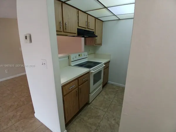 a kitchen with stainless steel appliances granite countertop a stove and a refrigerator