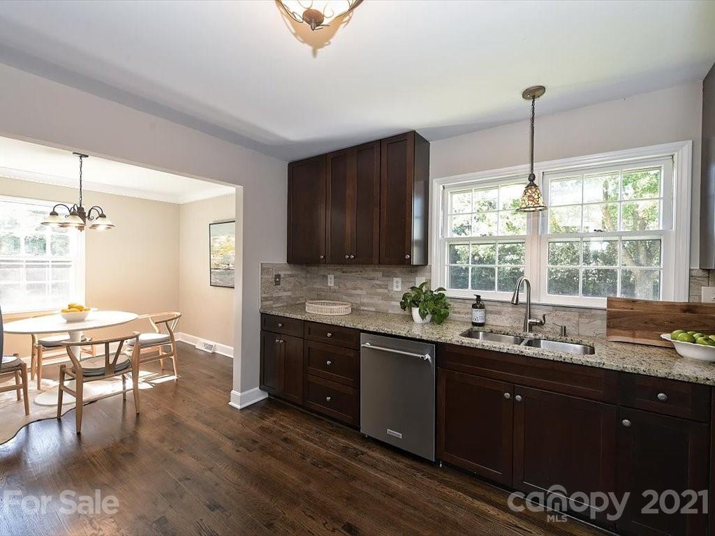 6918 Windyrush Road Charlotte, NC 28226 - Photo 11 of 26 a kitchen with a sink and wooden cabinets
