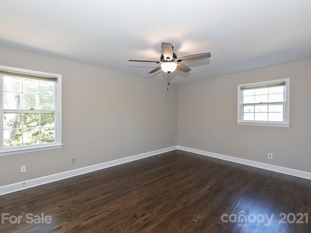 6918 Windyrush Road Charlotte, NC 28226 - Photo 12 of 26 a view of a big room with wooden floor and windows
