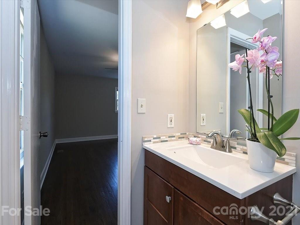 6918 Windyrush Road Charlotte, NC 28226 - Photo 13 of 26 a bathroom with a sink vanity and a mirror