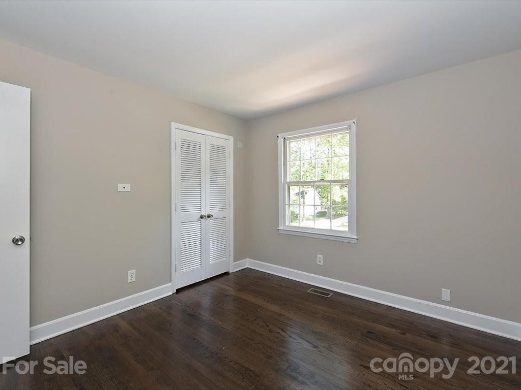6918 Windyrush Road Charlotte, NC 28226 - Photo 15 of 26 an empty room with wooden floor and windows