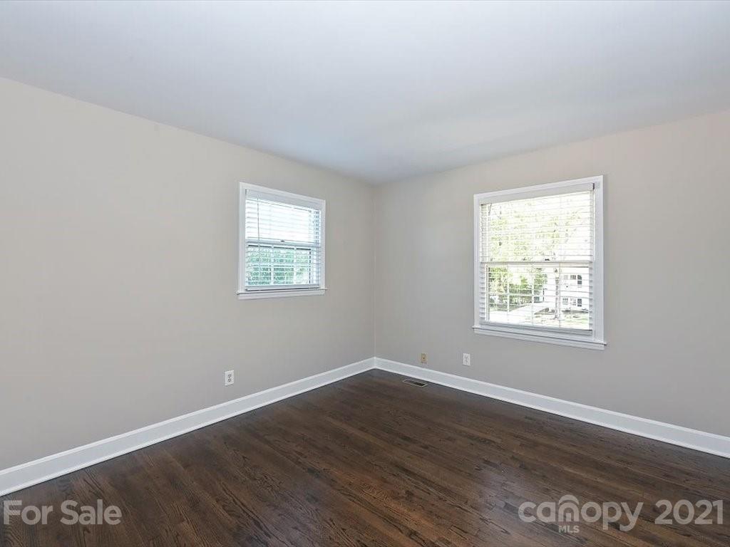 6918 Windyrush Road Charlotte, NC 28226 - Photo 17 of 26 an empty room with wooden floor and windows