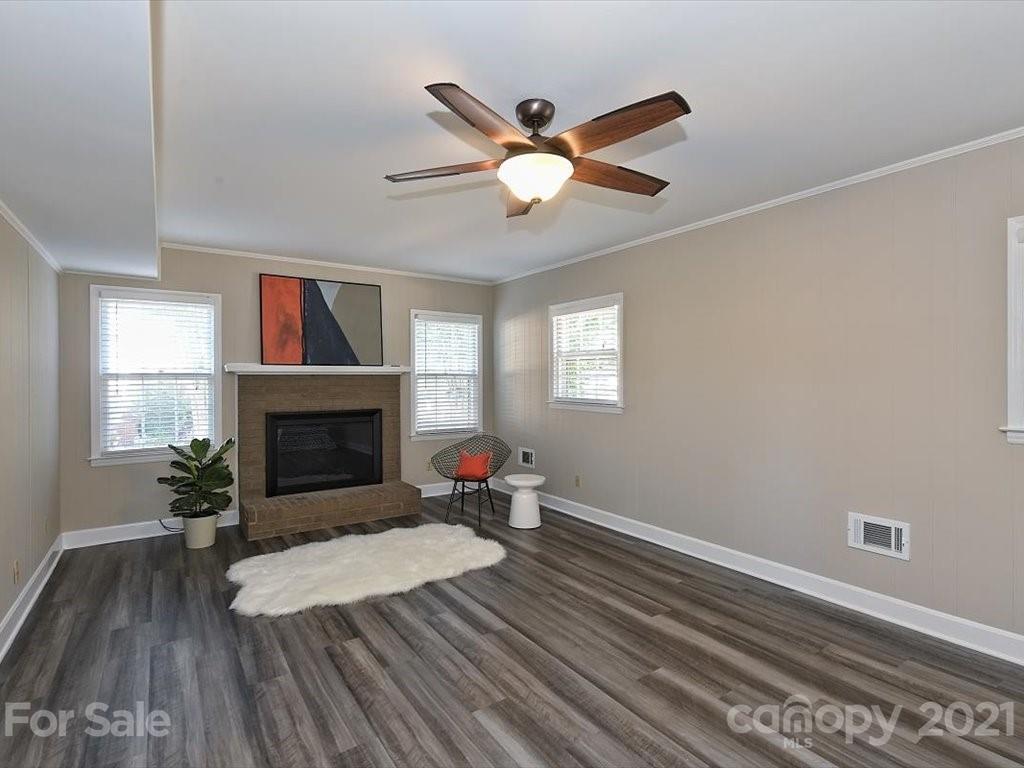 6918 Windyrush Road Charlotte, NC 28226 - Photo 19 of 26 a living room with furniture and a fireplace