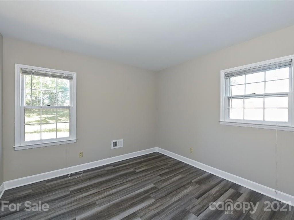 6918 Windyrush Road Charlotte, NC 28226 - Photo 21 of 26 an empty room with wooden floor and windows