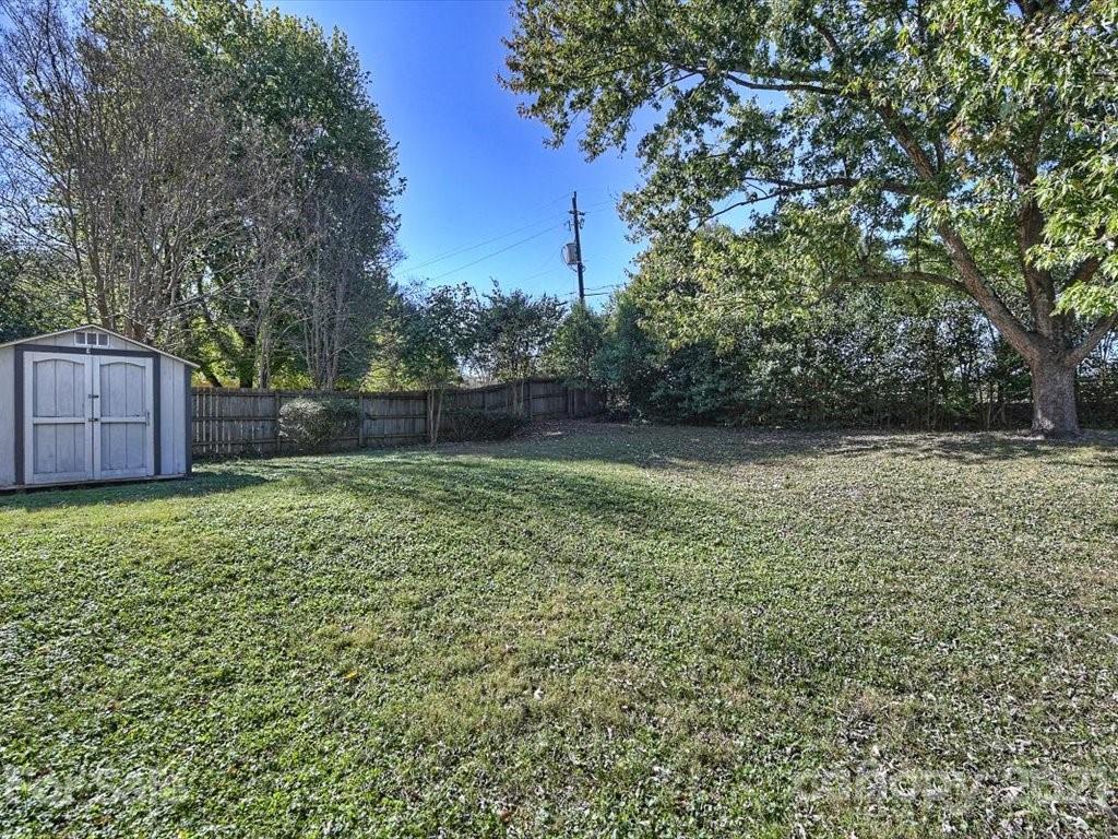 6918 Windyrush Road Charlotte, NC 28226 - Photo 23 of 26 a backyard of a house with lots of green space