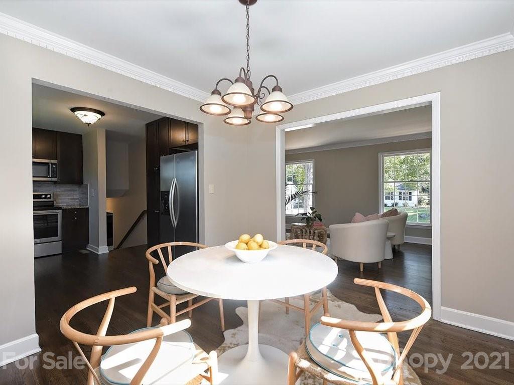 6918 Windyrush Road Charlotte, NC 28226 - Photo 6 of 26 a dining room with a table and chairs