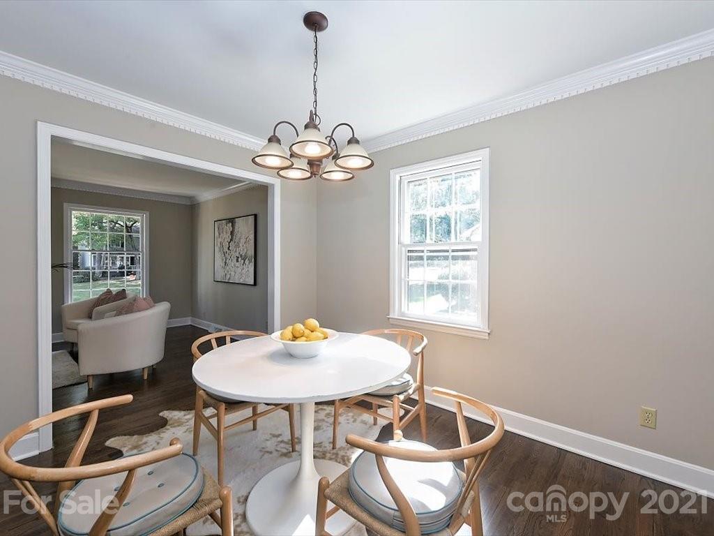 6918 Windyrush Road Charlotte, NC 28226 - Photo 8 of 26 a view of a dining room with furniture and chandelier