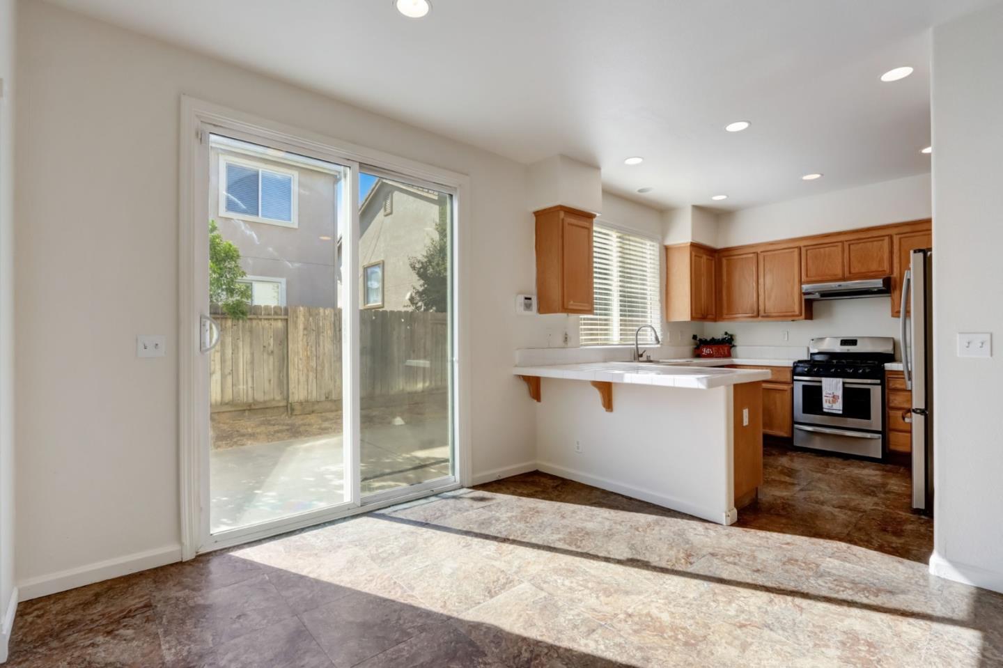 8911 Del Rio Circle Gilroy, CA 95020 - Photo 11 of 29 a view of kitchen with center island wooden floor and kitchen view