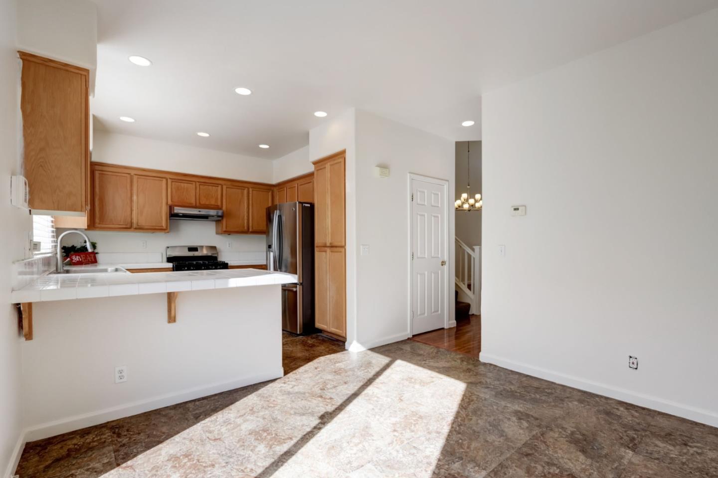 8911 Del Rio Circle Gilroy, CA 95020 - Photo 12 of 29 a kitchen with stainless steel appliances granite countertop a refrigerator and a sink