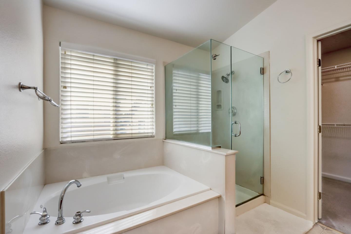 8911 Del Rio Circle Gilroy, CA 95020 - Photo 13 of 29 a bathroom with a bathtub and a shower