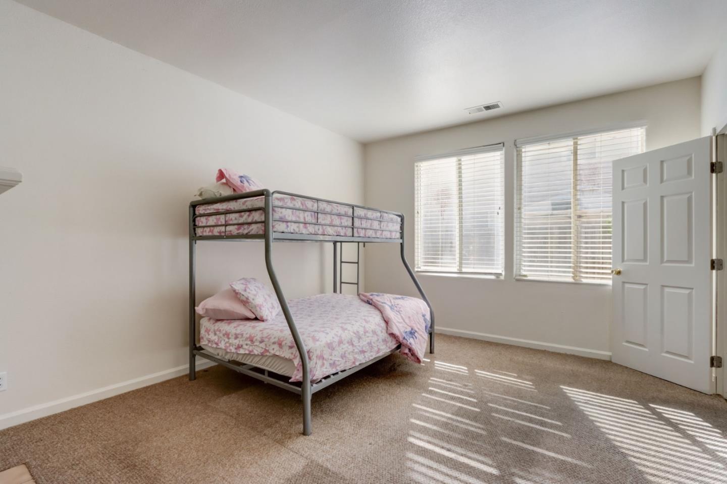 8911 Del Rio Circle Gilroy, CA 95020 - Photo 15 of 29 a bedroom with a bed a window and walk in closet