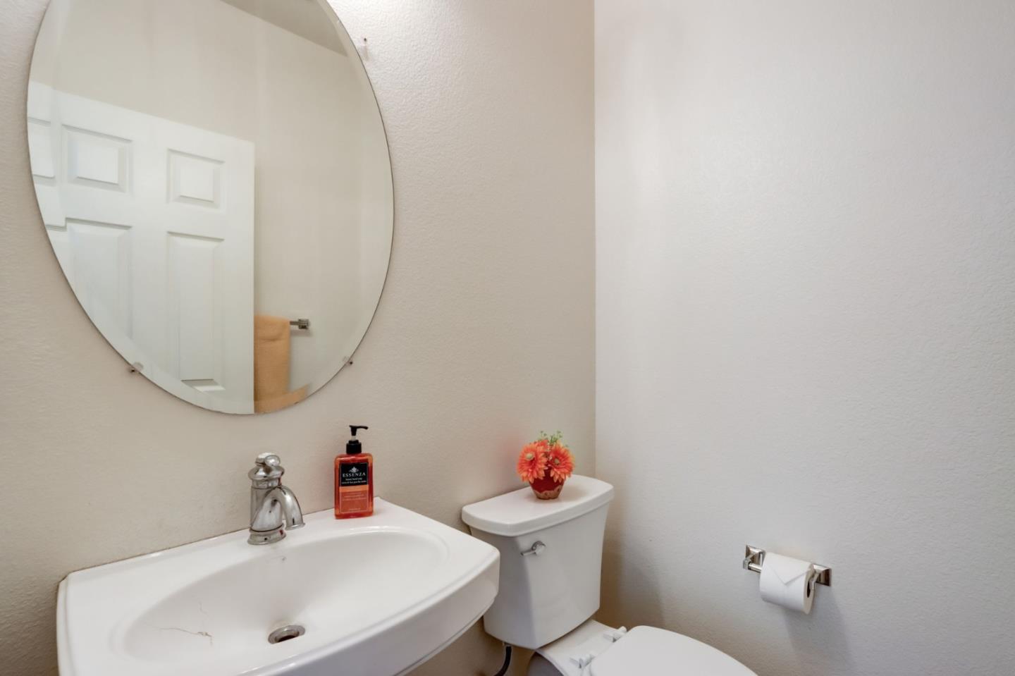 8911 Del Rio Circle Gilroy, CA 95020 - Photo 16 of 29 a bathroom with a sink mirror and toilet