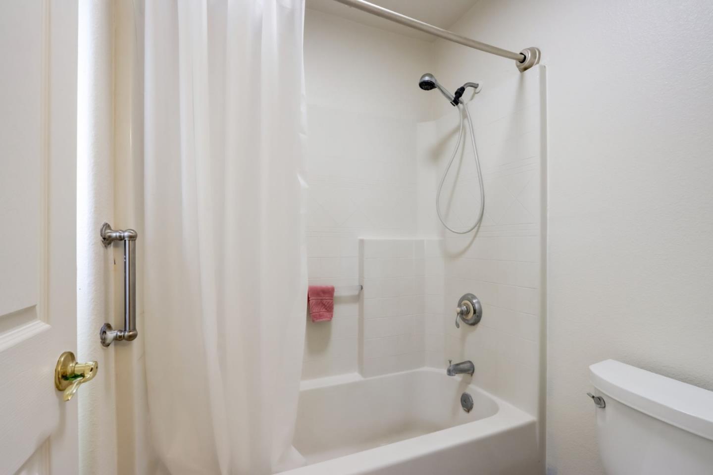 8911 Del Rio Circle Gilroy, CA 95020 - Photo 20 of 29 a bathroom with a bath tub with a shower