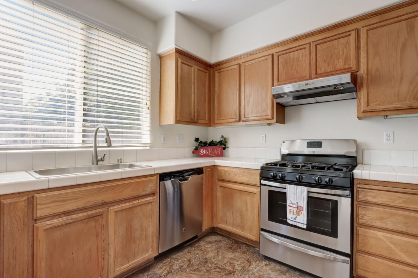 8911 Del Rio Circle Gilroy, CA 95020 - Photo 8 of 29 a kitchen with cabinets appliances a sink and a window