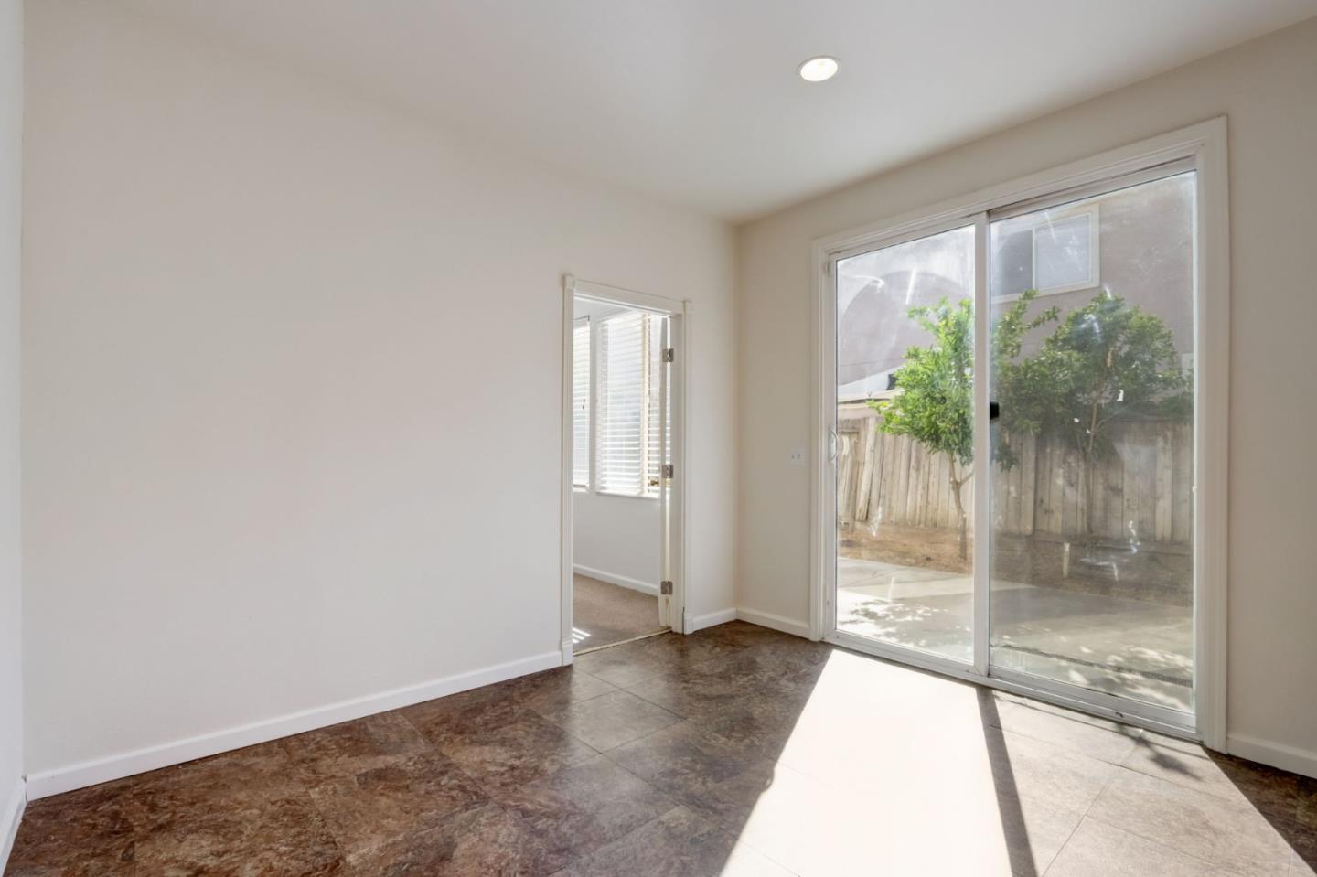 8911 Del Rio Circle Gilroy, CA 95020 - Photo 9 of 29 a view of empty room with wooden floor and floor to ceiling window