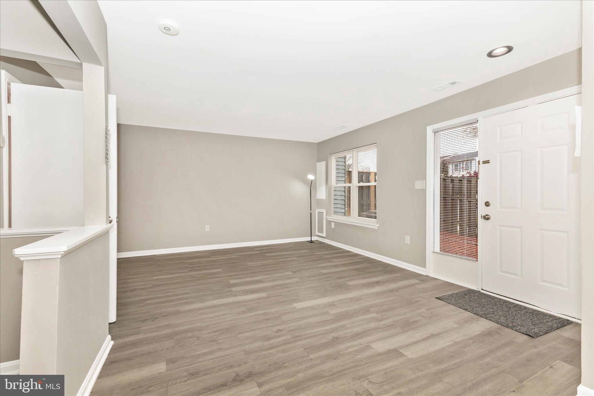 2861 Shepperton Terrace Silver Spring, MD 20904 - Photo 11 of 44 a view of an empty room with wooden floor and a window