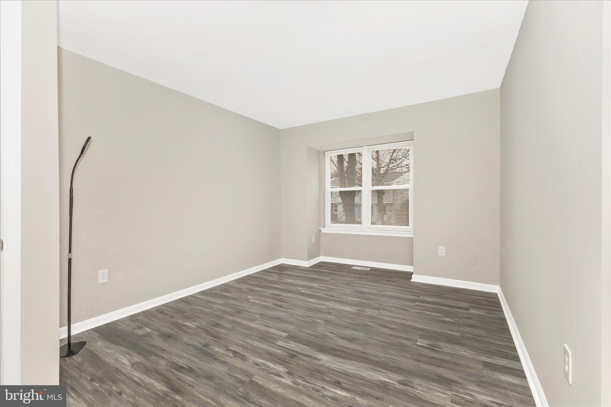 2861 Shepperton Terrace Silver Spring, MD 20904 - Photo 21 of 44 a view of an empty room with wooden floor and a window