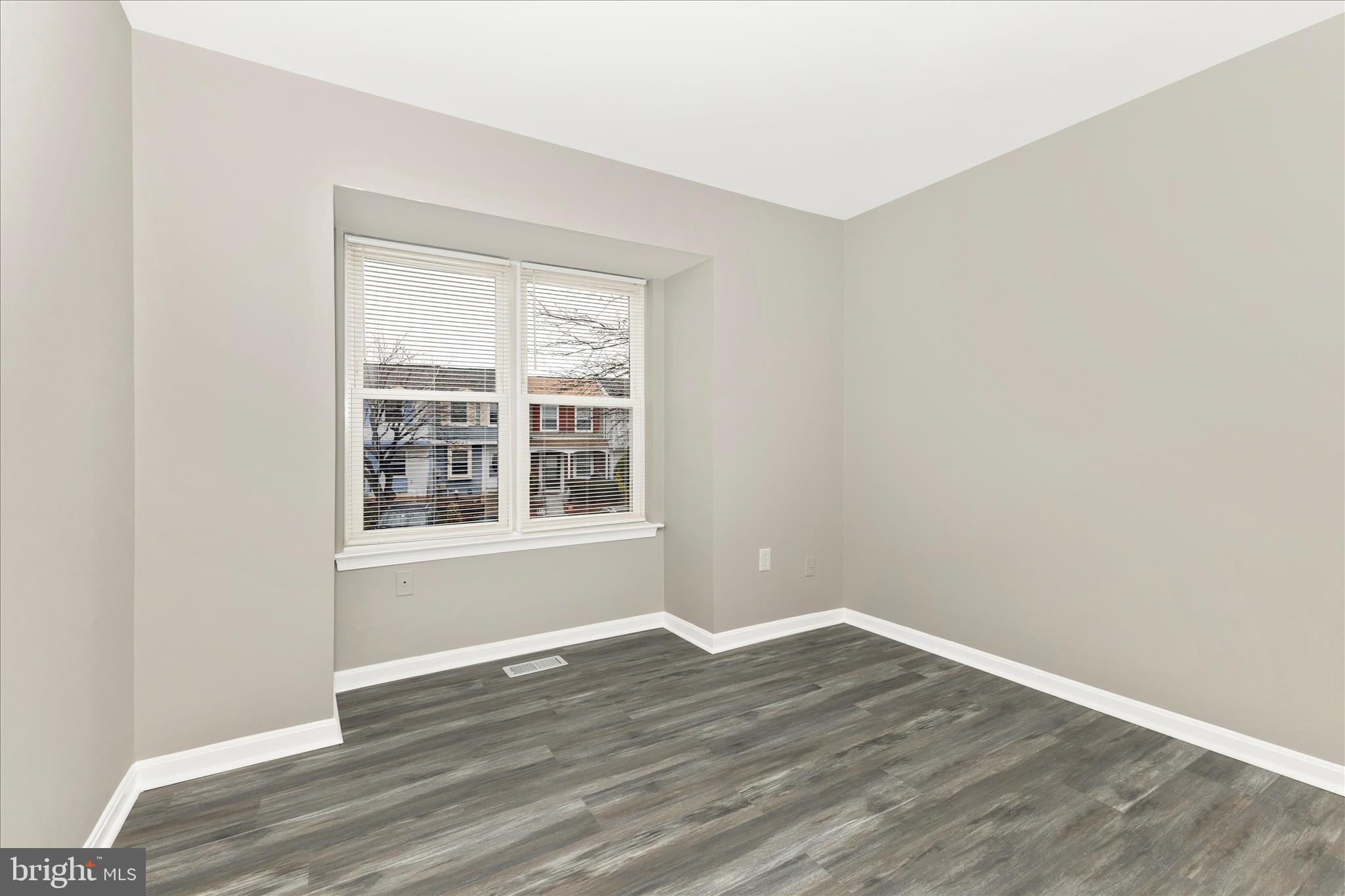 2861 Shepperton Terrace Silver Spring, MD 20904 - Photo 22 of 44 an empty room with wooden floor and windows