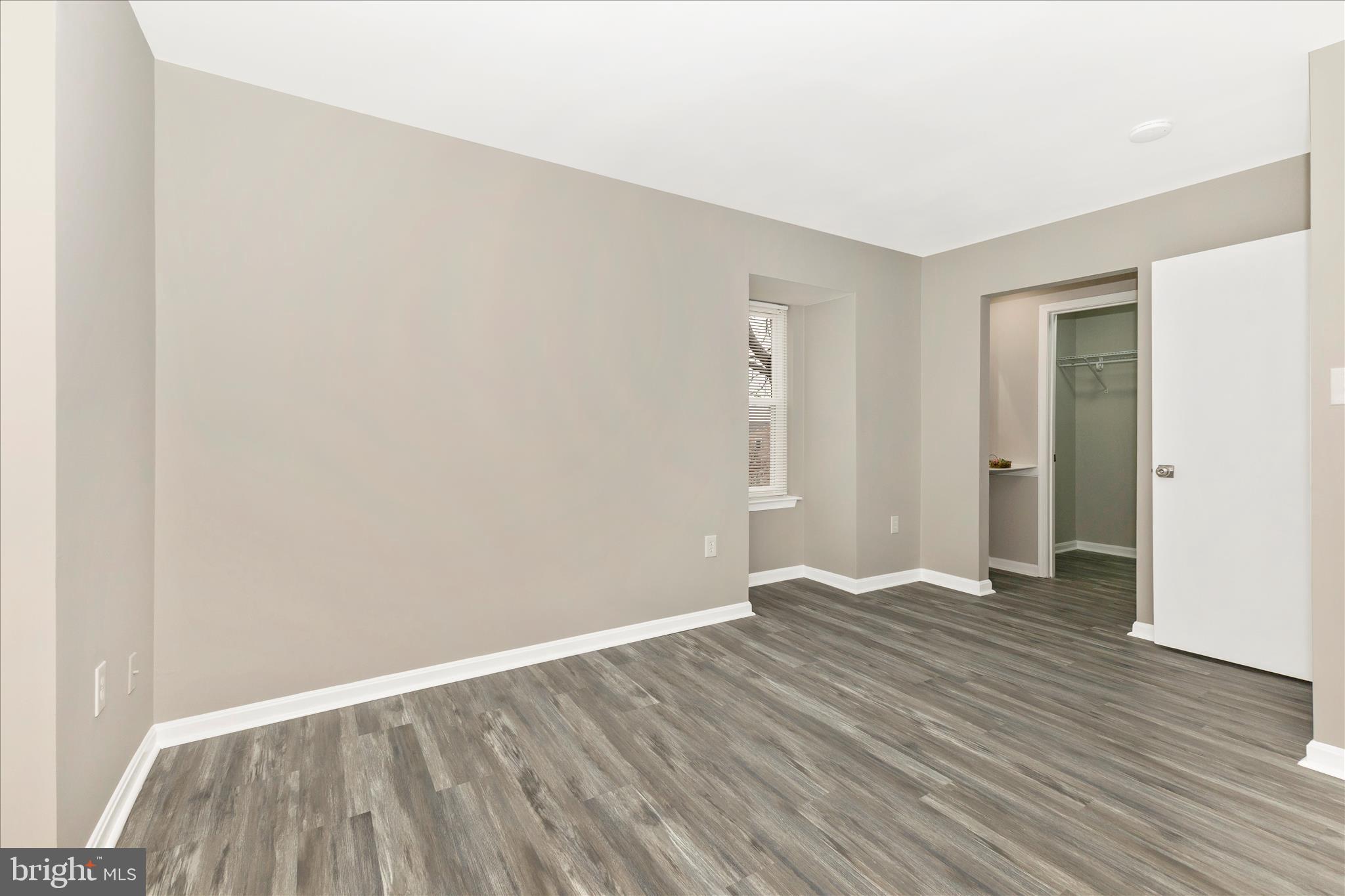 2861 Shepperton Terrace Silver Spring, MD 20904 - Photo 24 of 44 a view of an empty room with wooden floor and a window